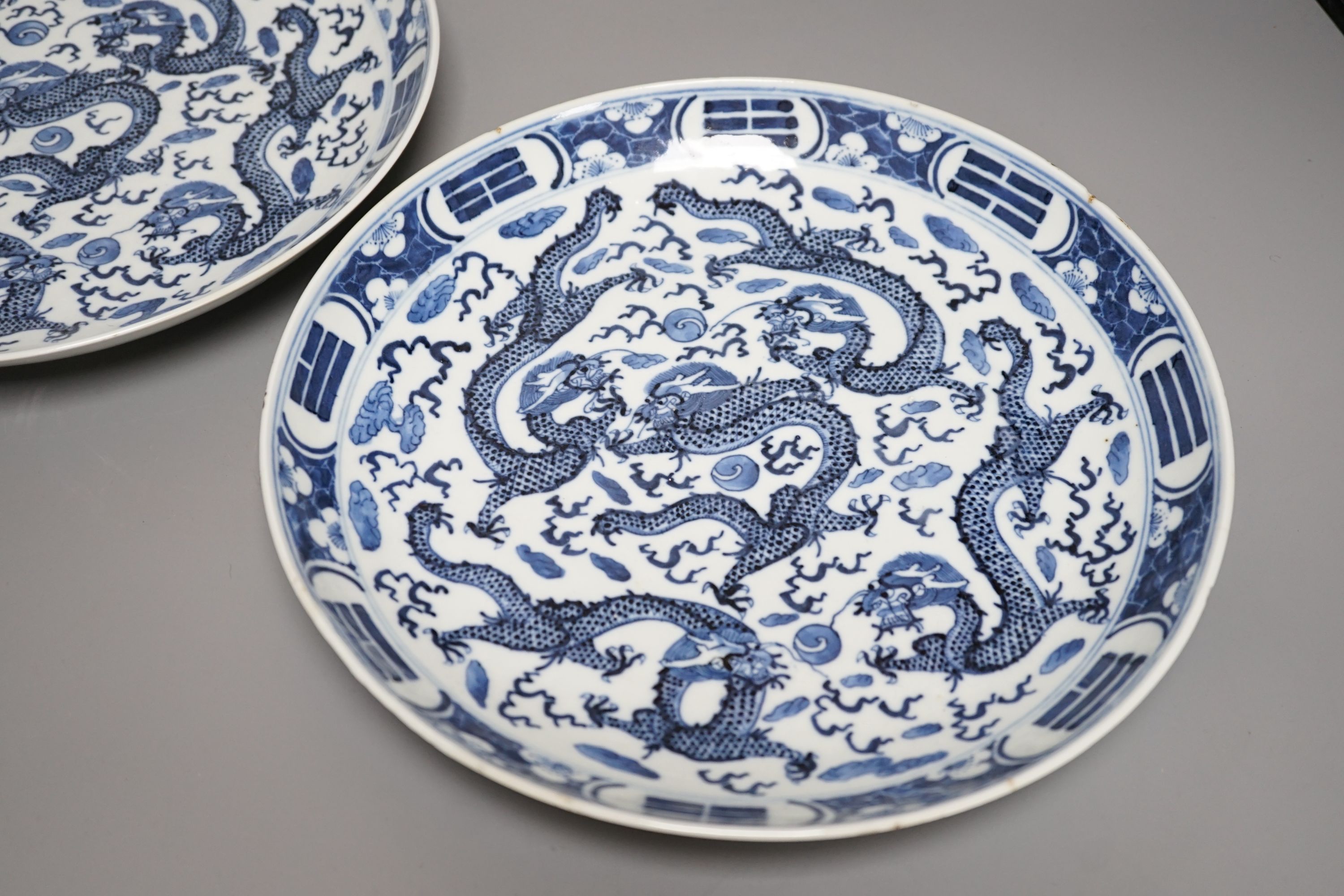 A pair of Chinese blue and white ‘dragon’ dishes, Qing dynasty, 27cm diameter